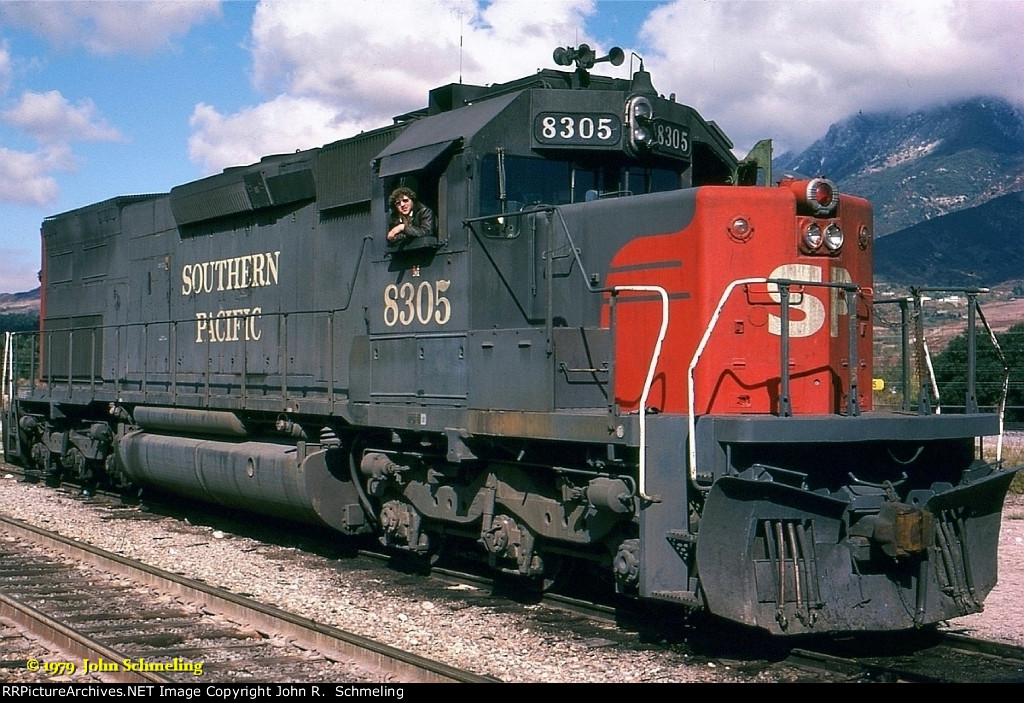 SP 8305 (SD40T-2) with yours truly hanging from the cab at the ripe old age of "21" I had just turned 21 four days earlier and I wish my hair still grew like that...Photo was taken by my friend Ed Smith who has sinced passed away. 5/27/1979 at Devore CA.